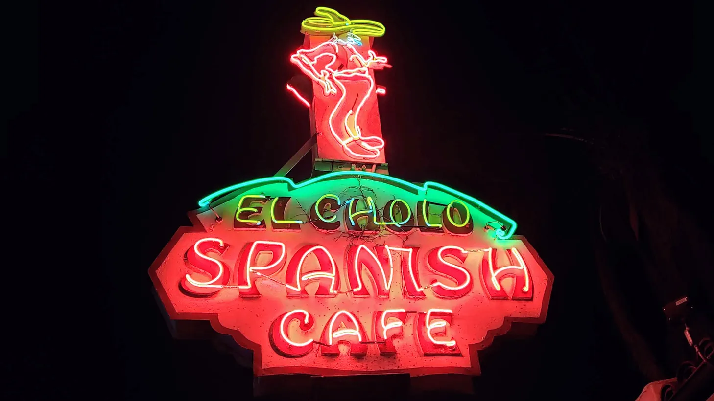 The sign for El Cholo on Western Ave. is illuminated against the night sky.