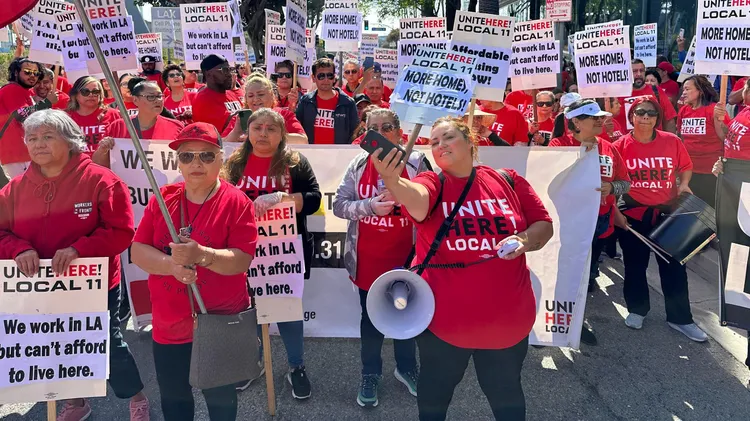 Unionized hotel workers in Los Angeles and Orange Counties are demanding raises, saying they can no longer afford to live in the cities where they work.