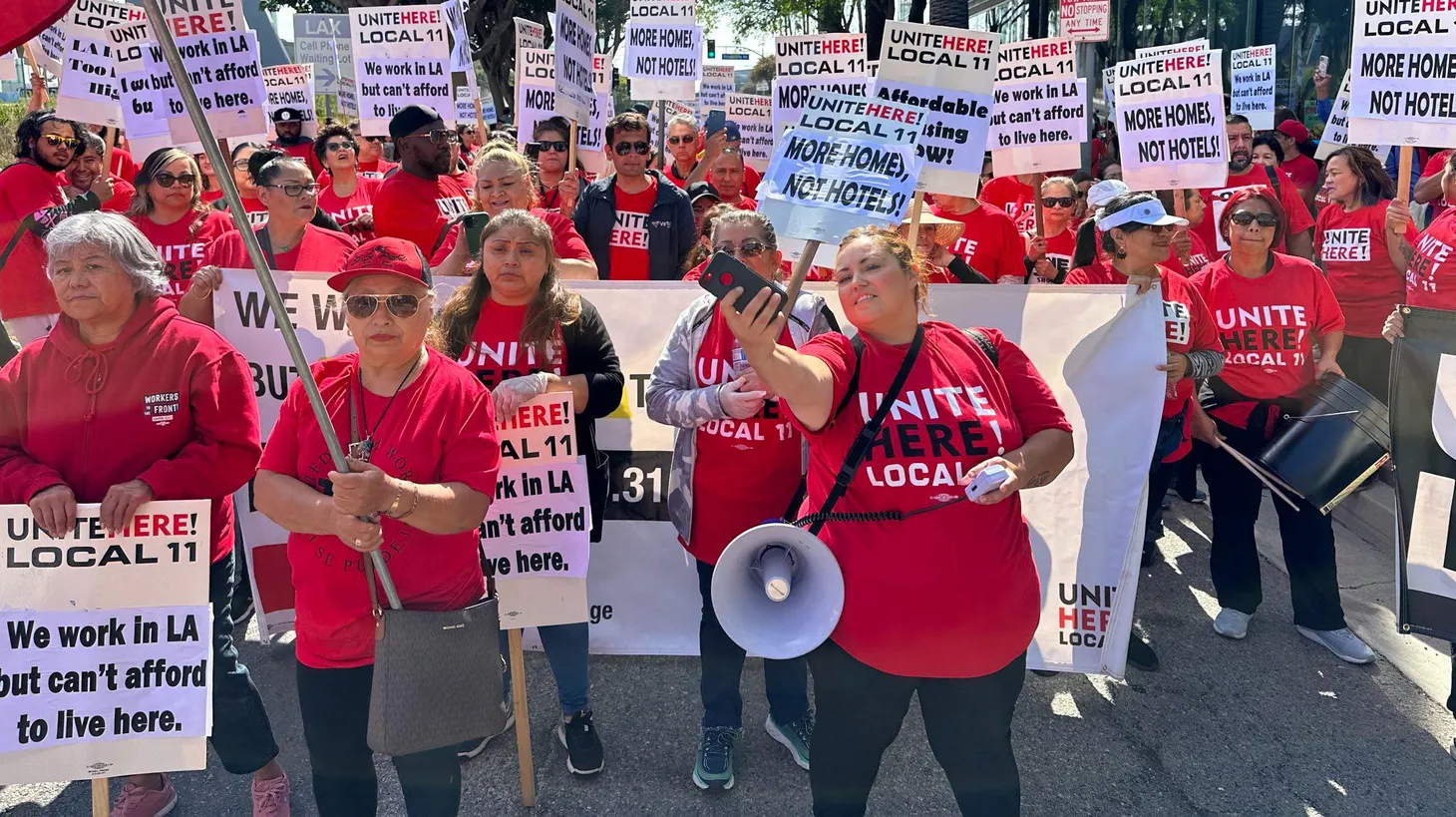 Hotel housekeepers, cooks, and servers represented by Unite Here Local 11 hold a demonstration in June. The union is threatening to strike this weekend if they don’t reach an agreement with management on a new contract.