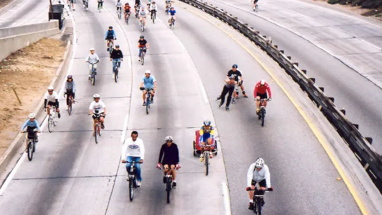 People ride bikes on the 110 freeway during ArroyoFest 2003.