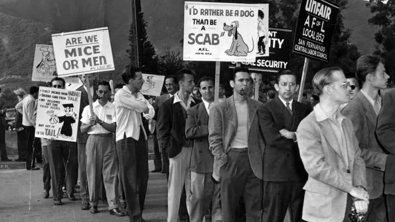 May 28, 1941: Workers are shown picketing Walt Disney studios after a strike call. Some of the placards they carry show pictures of Disney characters and slogans such as “Are We Mice or Men?"