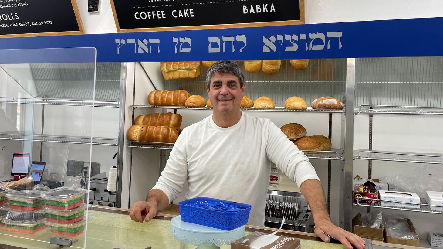 Owner Doug Weinstein stands behind the counter of Diamond Bakery on its last day in business.