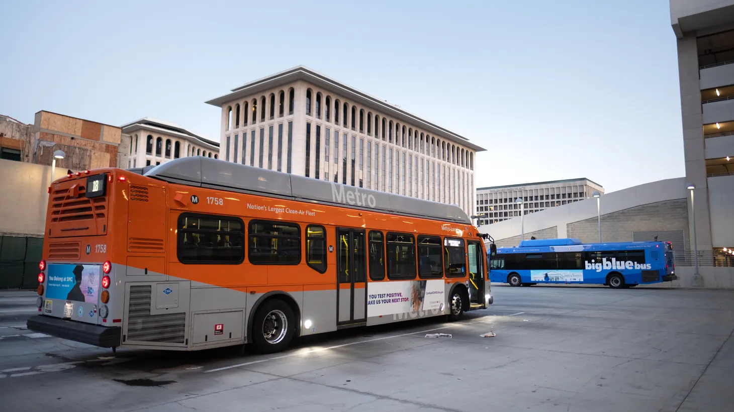 An LA Metro bus and Big Blue bus are stationed in Koreatown. Last month, nearly one in five Metro buses got canceled.