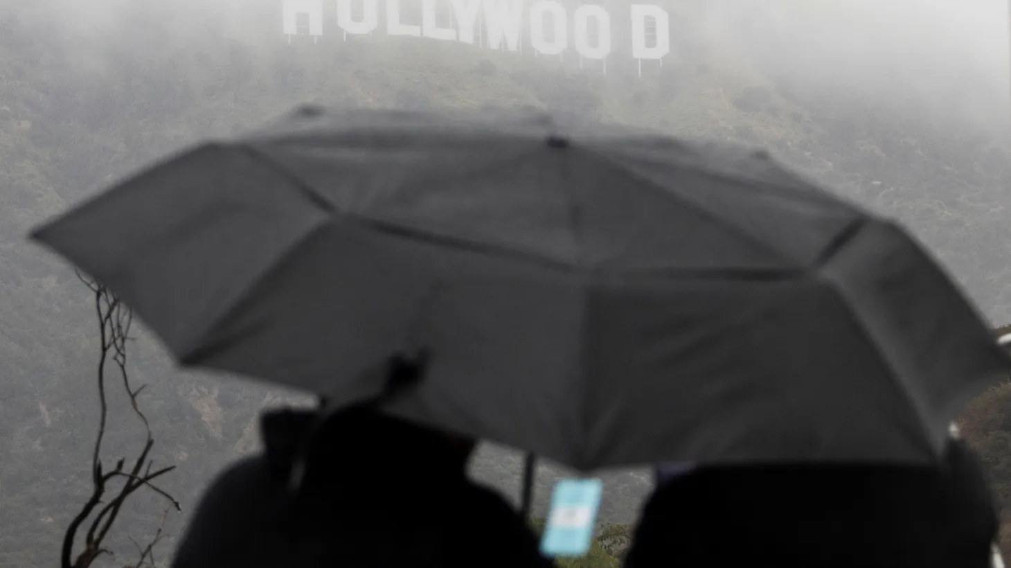 Visitors look at the Hollywood sign during a rare cold winter storm in Los Angeles, California, U.S., February 24, 2023.