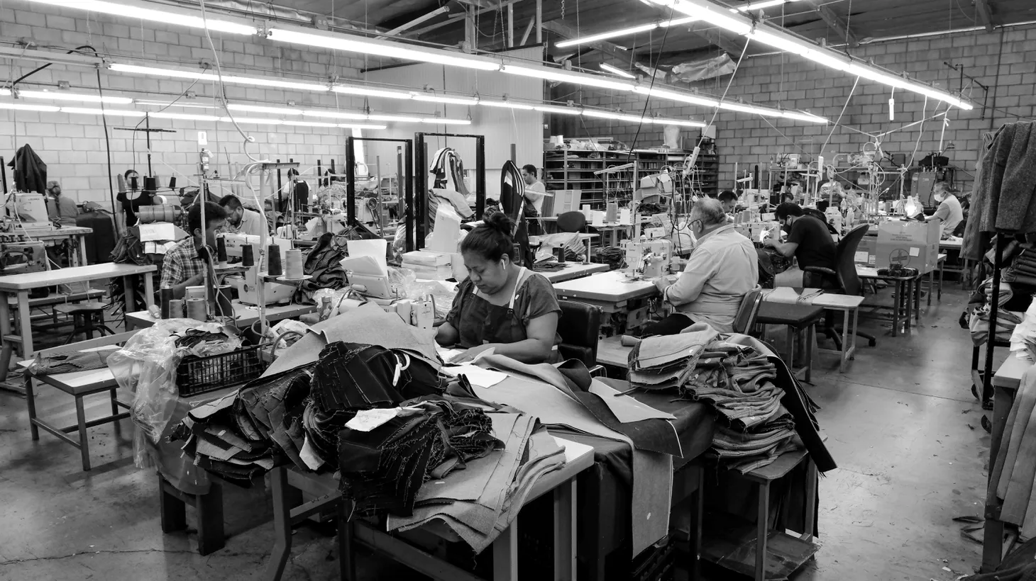 Under fluorescent light, men and women stay focused during the work day at 9B Apparel in Huntington Park. August 26, 2022.