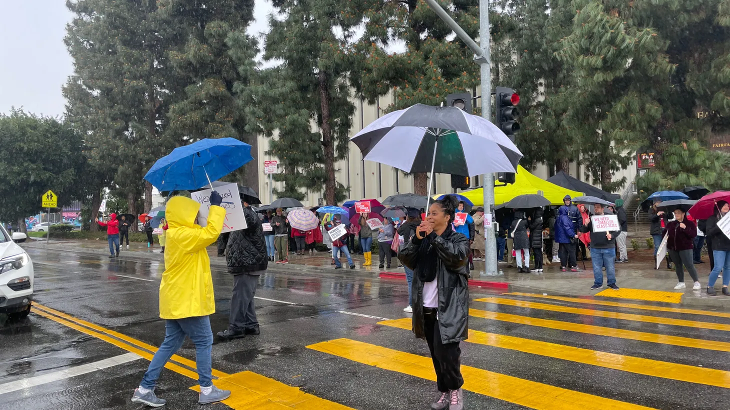 Teachers and support staff rally outside of LA’s Fairfax High School on a rainy first morning of the three-day strike.