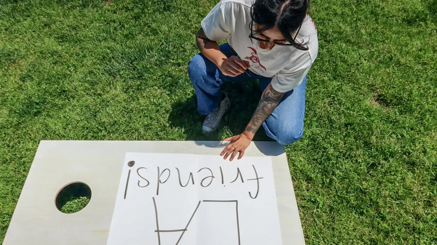 Emmely Avila makes a sign to help members of the Los Angeles Friends TikTok group find each other in person. "Sometimes our friends are our family,” says Avila, who started the group to make friends. “I want that for everybody. Everybody deserves a friend.”