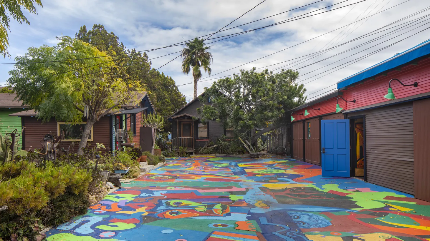 The driveway and gathering space at St. Elmo Village was created by artists Rozzell Sykes and Roderick Sykes as a nonprofit rental complex focused on the arts and community engagement.