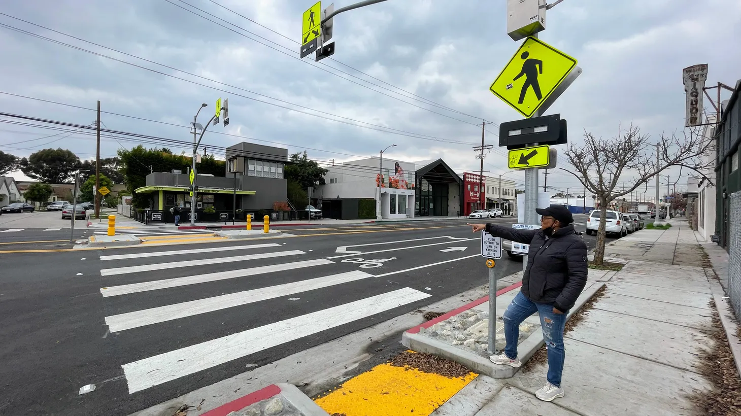Yolanda Davis-Overstreet, a community organizer and mobility justice advocate, points to a crosswalk on West Adams Boulevard that she helped bring to the neighborhood through the City of LA’s Vision Zero.