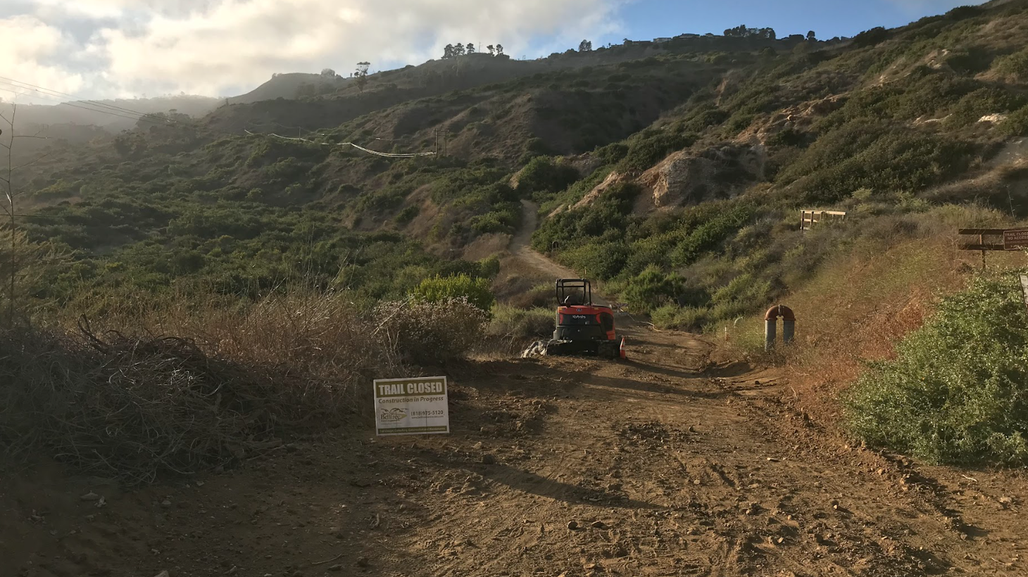 Before the full trail closures in the Portuguese Bend Reserve in Rancho Palos Verdes, crews work to fill fissures that started opening in spring of 2023, after a winter of heavy rains.
