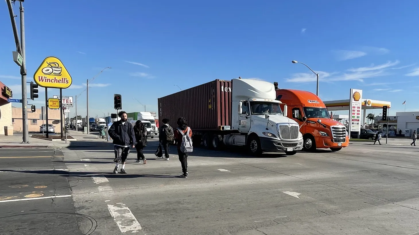 Cargo trucks haul shipping containers through West Long Beach at the corner of Pacific Coast Highway and Santa Fe Avenue. Toxic emissions from trucks, trains and ships related to port activity were up in 2021. December 15, 2021.