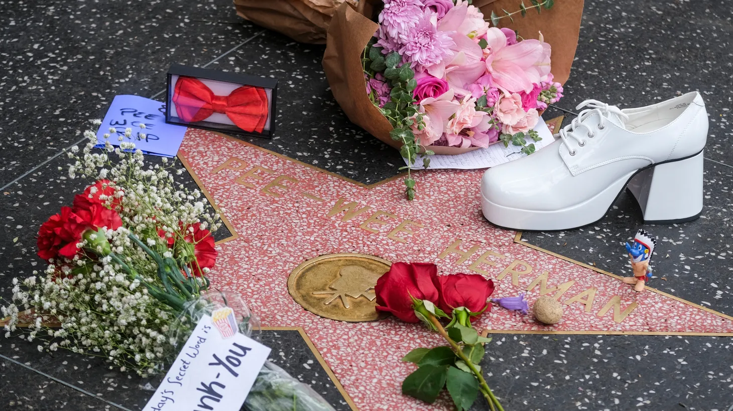 Fans left remembrances for Paul Reubens on his Hollywood Walk of Fame star, even a signature platform shoe.