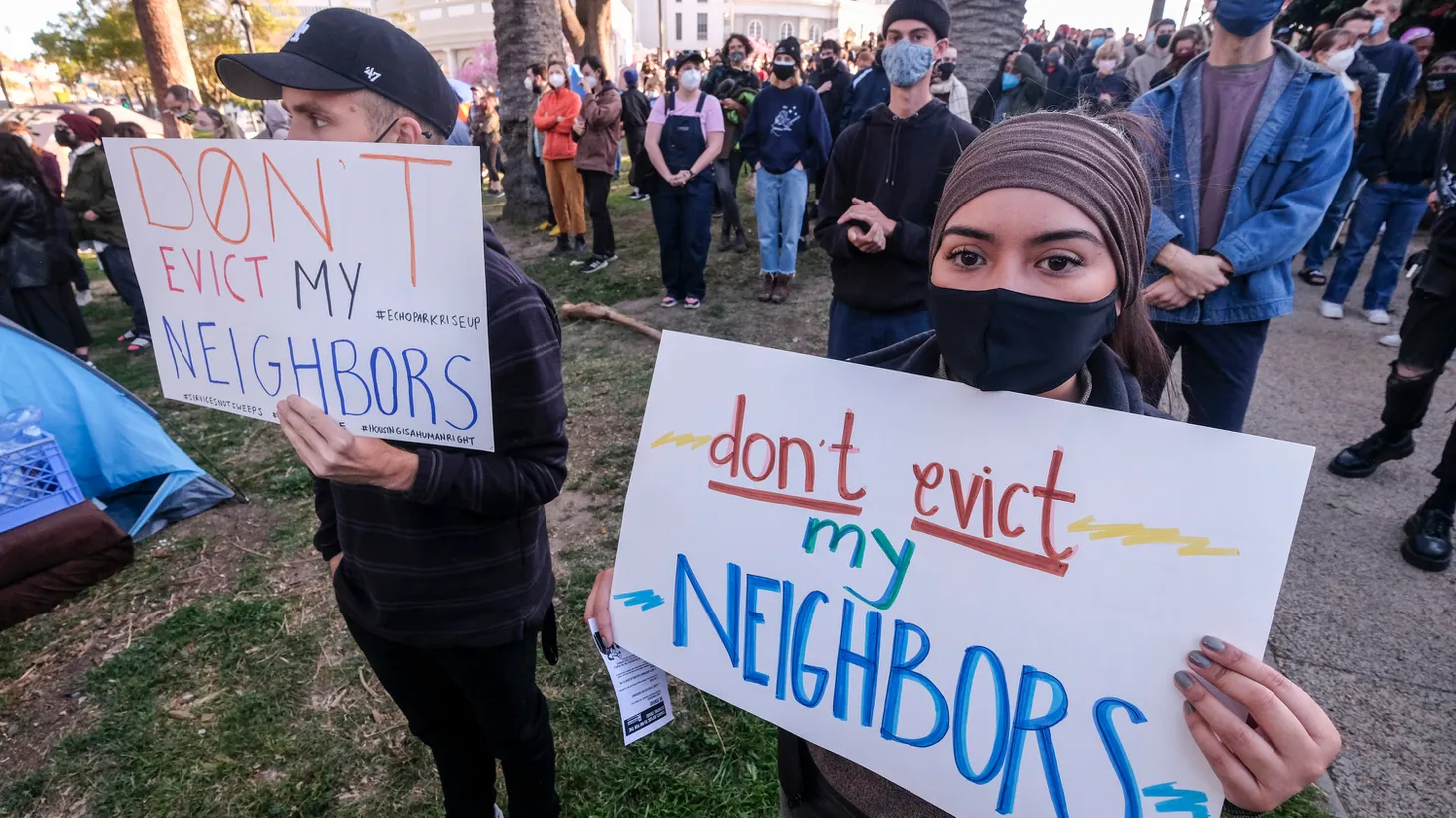Activists hold signs that say “don’t evict my neighbors,” in Echo Park, Los Angeles, March 24, 2021.