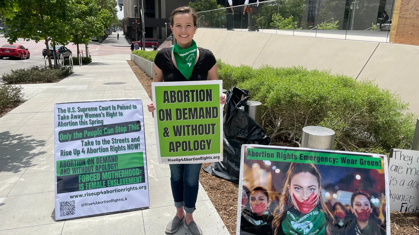 Skyler Soloman handed out green scarves to demonstrators because it has come to symbolize the pro-choice movement.