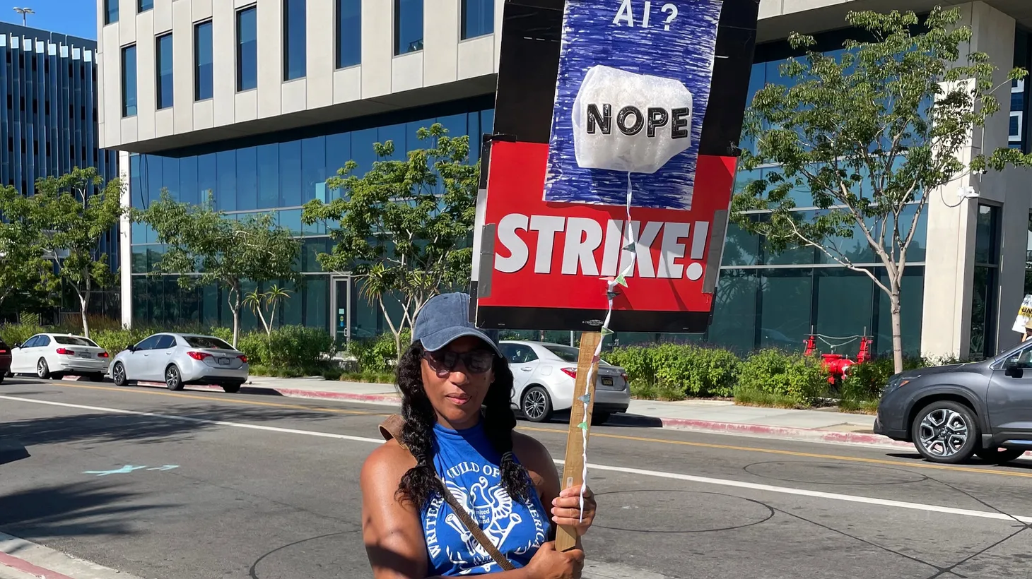 Writers Guild member Melody Cooper picketed in front of Netflix in May. Artificial Intelligence is a primary concern not only for writers and actors, but for workers throughout Hollywood.