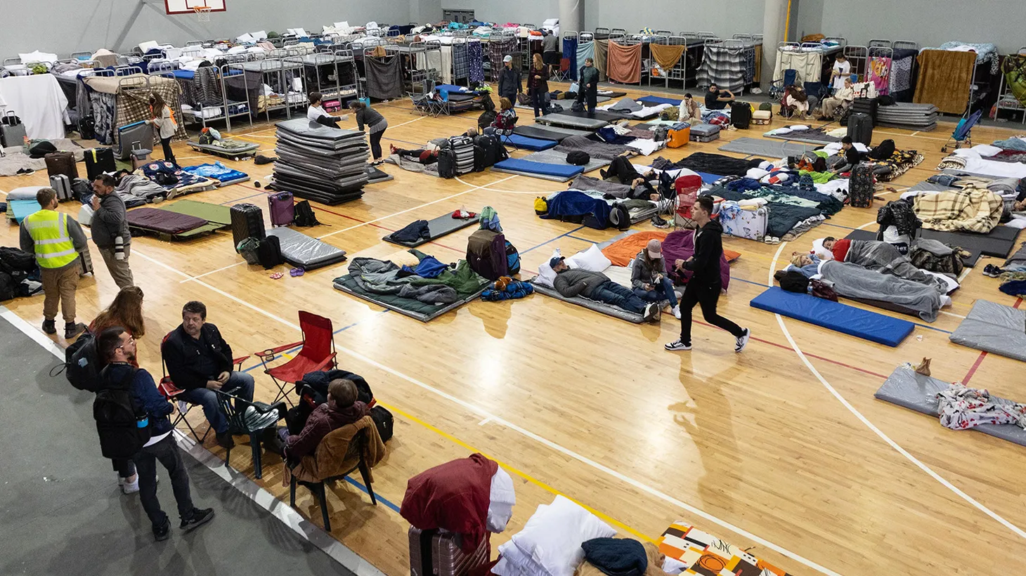 The Benito Juárez sports complex is lined with dozens of bunk beds and hundreds of sleeping mats, housing thousands of Ukrainian refugees seeking to reunite with their families in the United States.