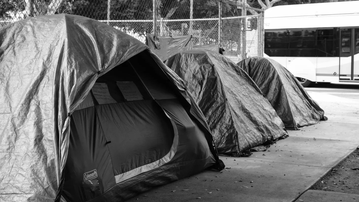 A bus drives by three homeless tents that are lined up near LA City Hall. Last year’s count found more than 69,000 people living in tents, shelters, cars, and on the streets of Los Angeles County.