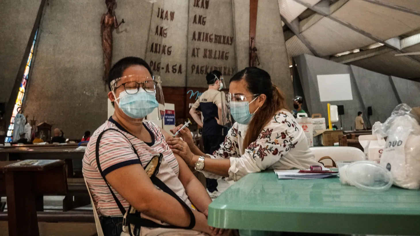 Filipinos receive the AstraZeneca COVID-19 vaccine at Immaculate Heart of Mary parish in Quezon City, Philippines, August 13, 2021.