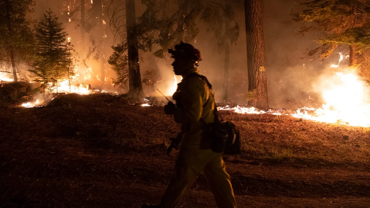 Firefighters protect homes in Christmas Valley from the Caldor Fire on Monday, Aug. 30, 2021.