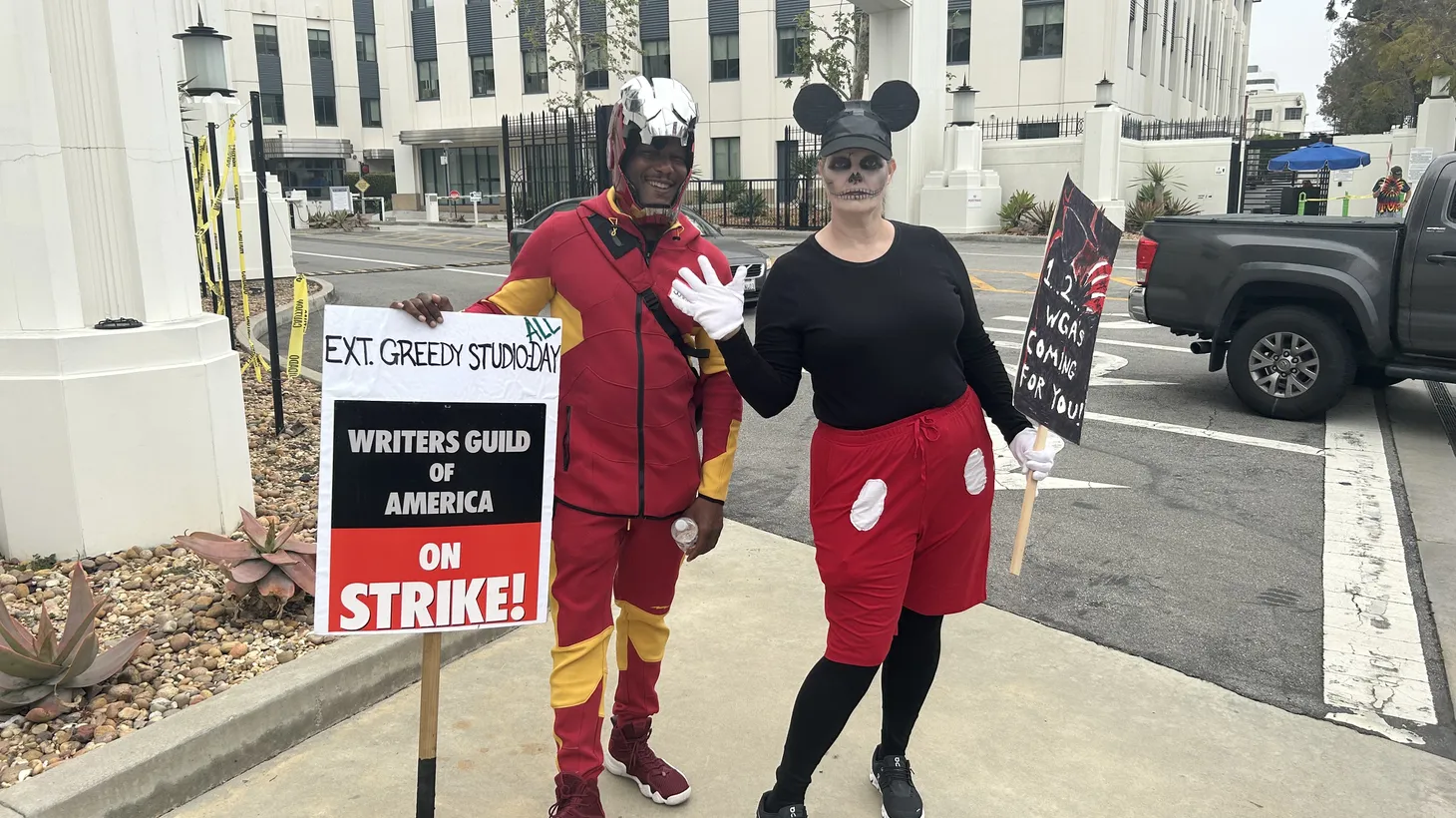 Writers Jonathan Butler and Alyssa Clark dressed up as dead Mickey and Iron Man during a Halloween-themed picket at Sony studios.