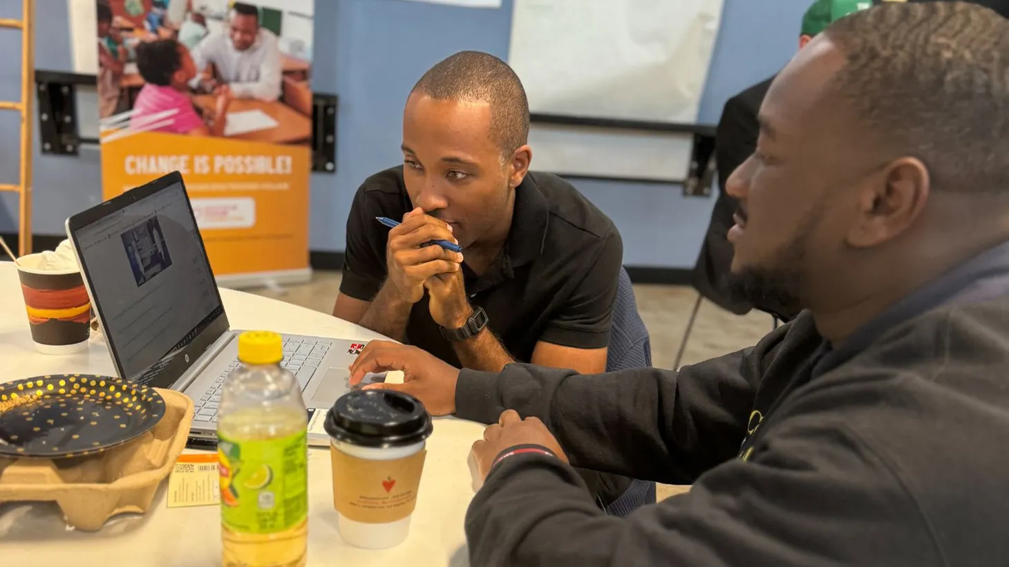 Teacher Village fellow Avery Watts (right) uses the EduCare SIMS game during a Components of Care training session. Next to him is Joshua Payne (left), a former student of Dr. Peter Watts, who now works as a teacher.