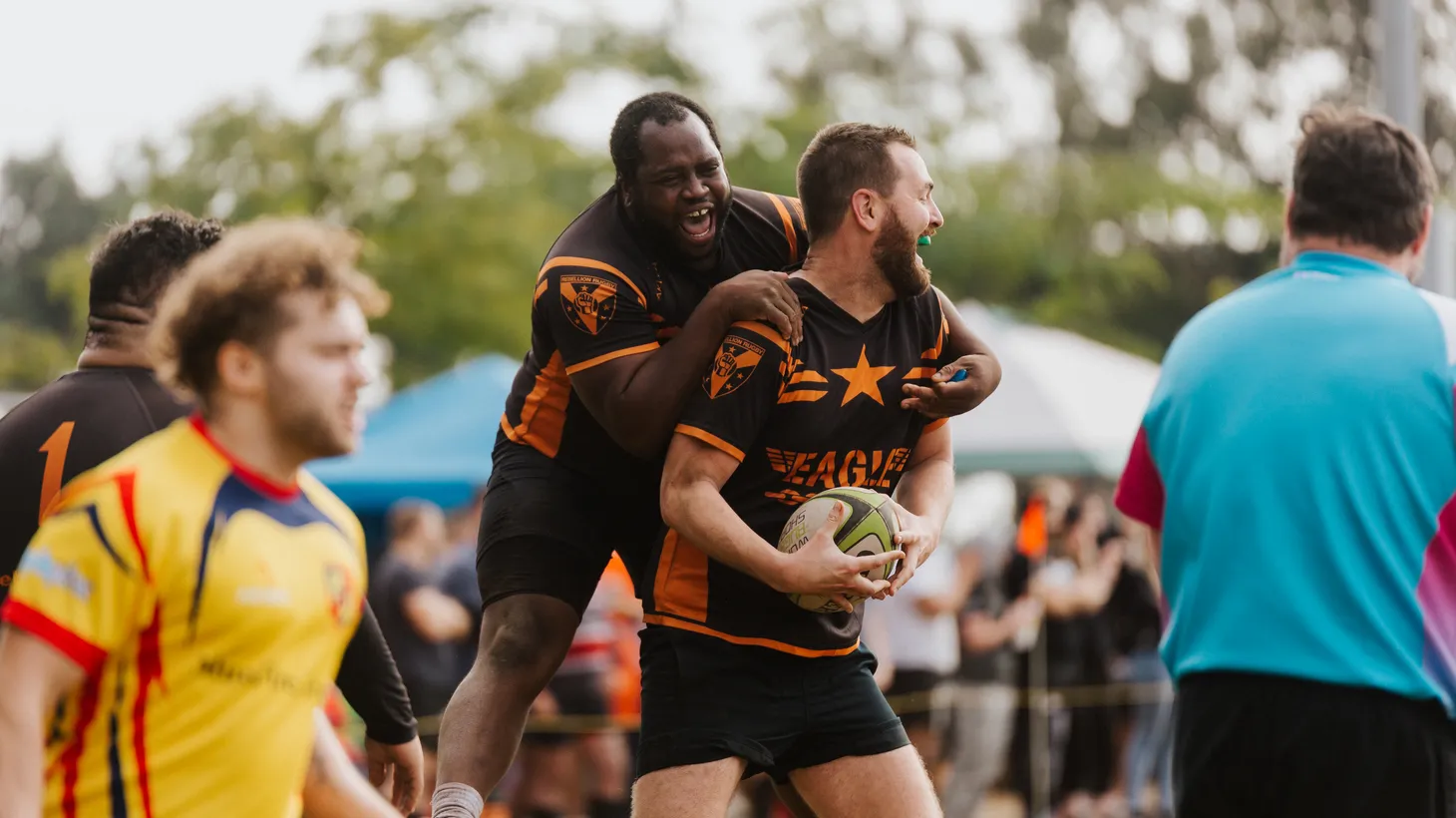Two Rebellion rugby players celebrate after scoring.