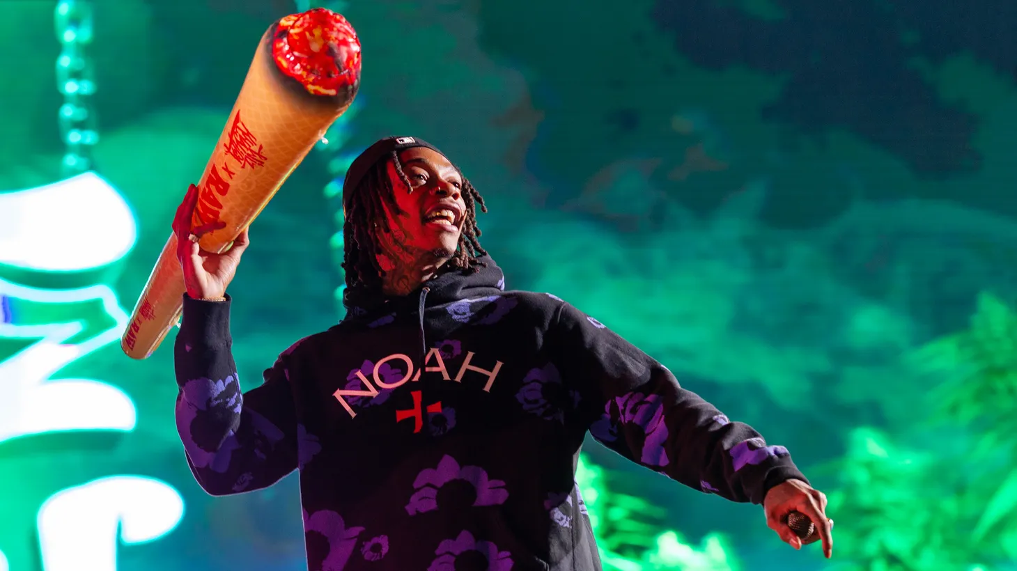 Rapper Wiz Khalifa holds a blow-up joint during a performance. “[Celebrities] already have built in followers and a fan base that drives brand awareness. That's a big deal in the cannabis space,” says Leafly Senior Editor David Downs.