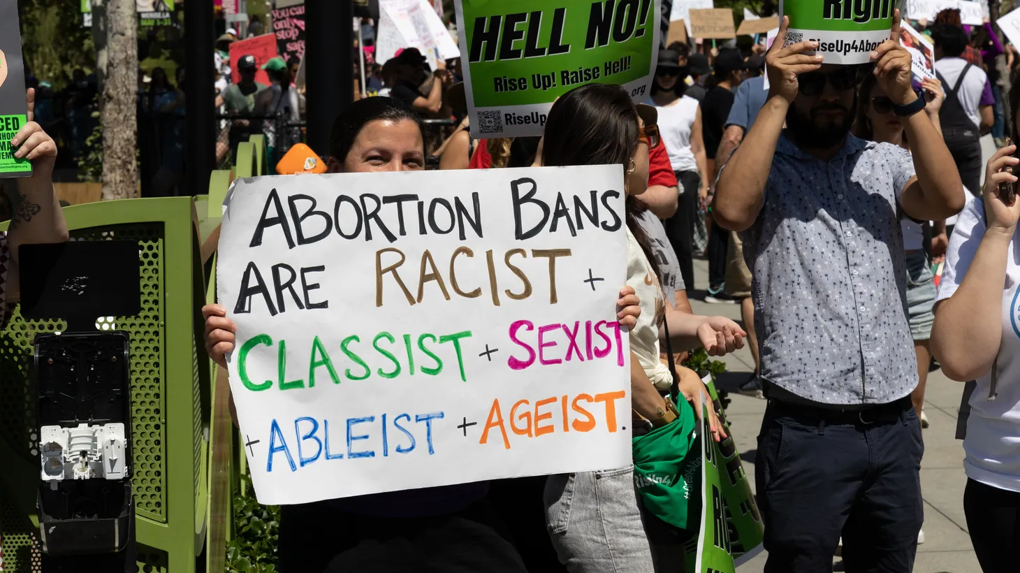 An activist at an abortion rights rally holds a sign saying, "Abortion bans are racist + classist + sexist + ableist + ageist," Los Angeles, CA, May 14, 2022.