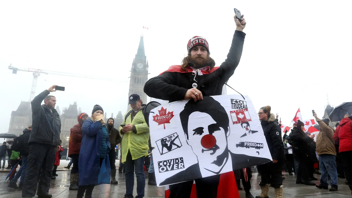 A person holds a sign of Canada's Prime Minister Justin Trudeau on Parliament Hill, as truckers and their supporters continue to protest COVID-19 vaccine mandates, in Ottawa, Canada, Feb. 17, 2022.