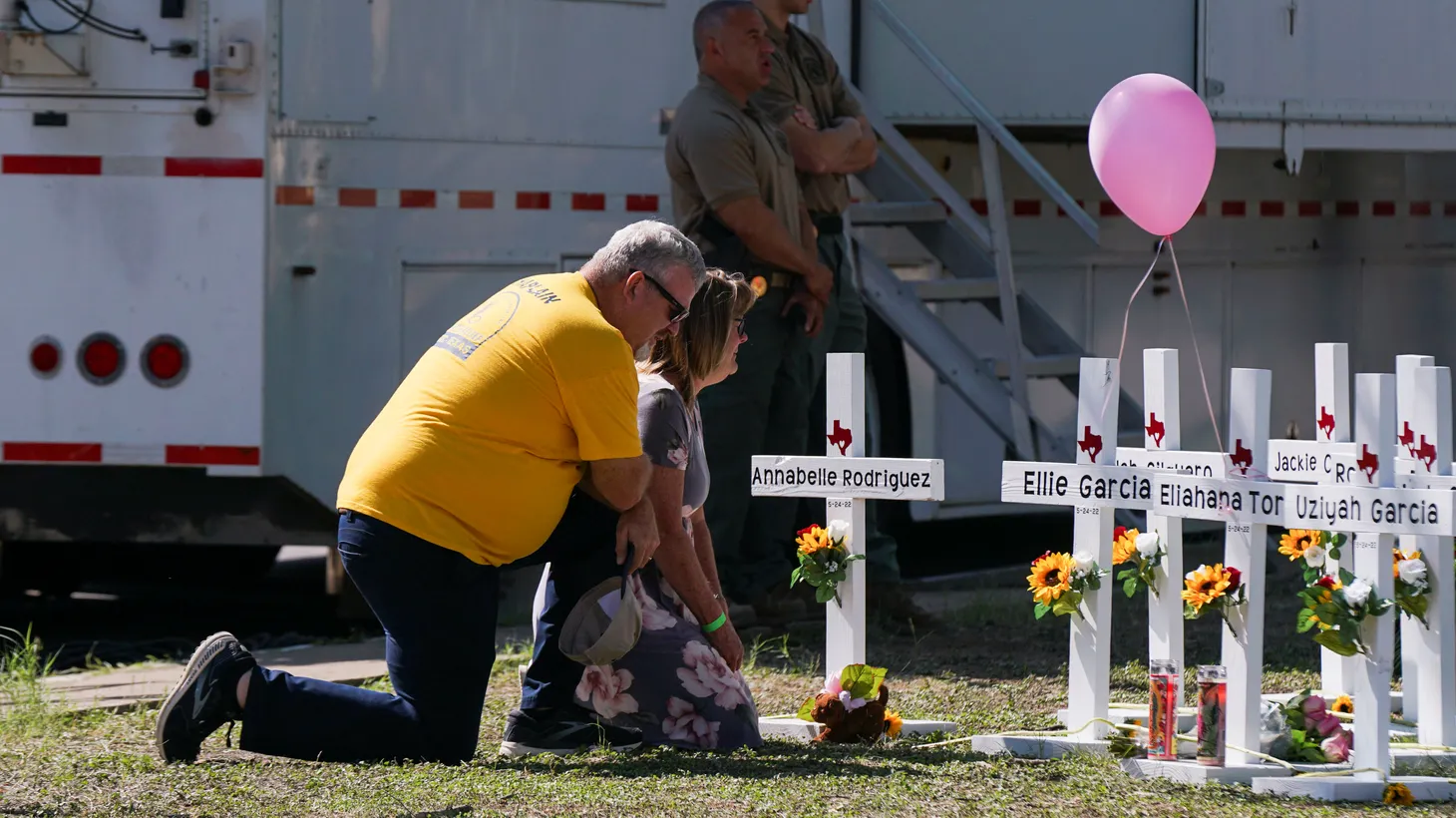 People mourn in front of memorial crosses for the victims of the mass shooting at Robb Elementary School in Uvalde, Texas, U.S., May 26, 2022. REUTERS/.