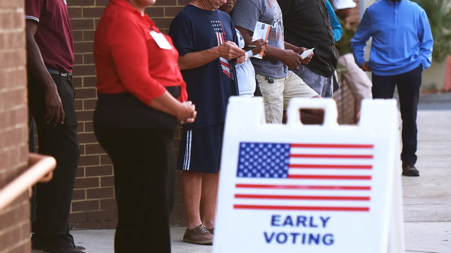 People wait in line to cast their ballots at the Orange County Supervisor of Elections Office on the first day of early voting for the 2022 midterm general election in Orlando, October 24, 2022.