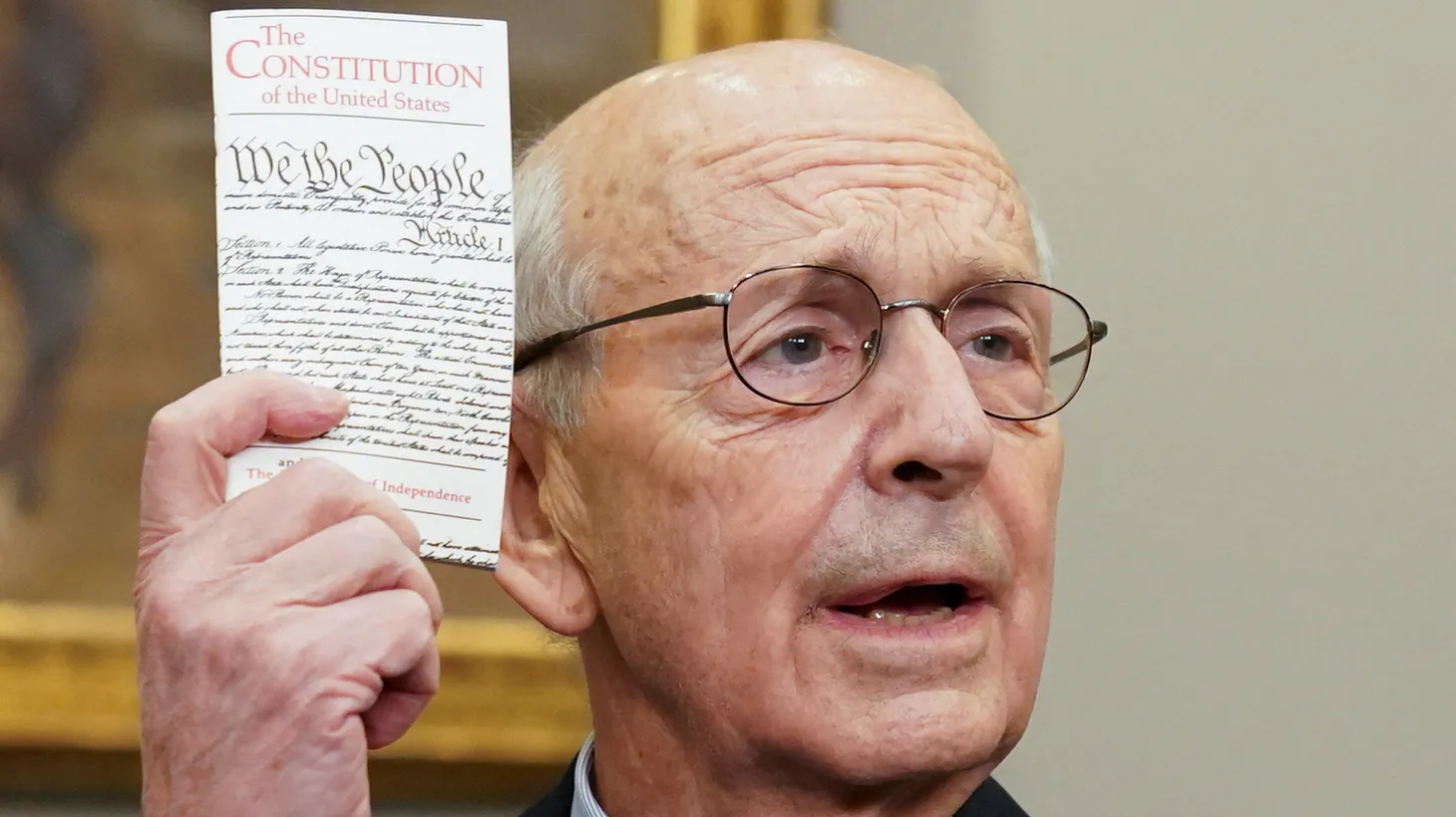 U.S. Supreme Court Justice Stephen Breyer holds up a copy of the U.S. Constitution while announcing he will retire at the end of the court's current term, at the White House. January 27, 2022.