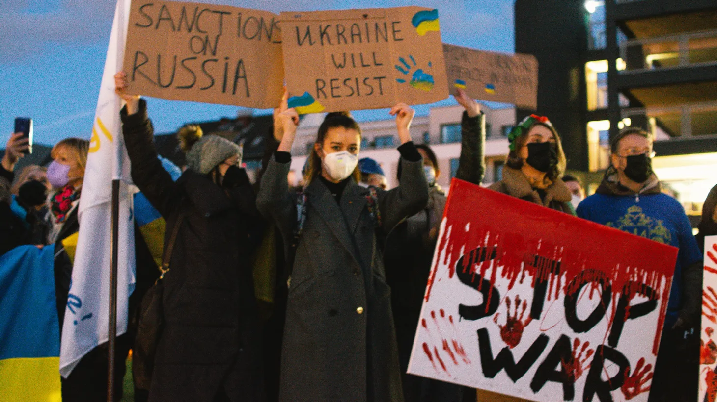 Protesters hold the signs of " Ukraine will resist" and "Stop War " during the protest in front of State parlament in Duesseldorf, Germany on Feb 23, 2022