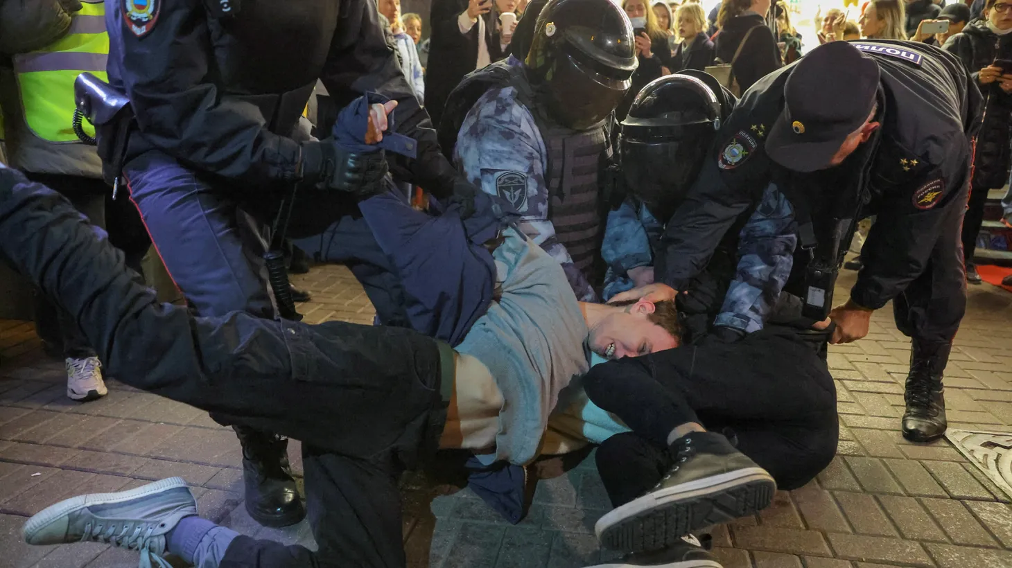 Russian law enforcement officers detain men at a street protest against President Vladimir Putin’s call for the mobilization of reservists, in Moscow, Russia, September 21, 2022.