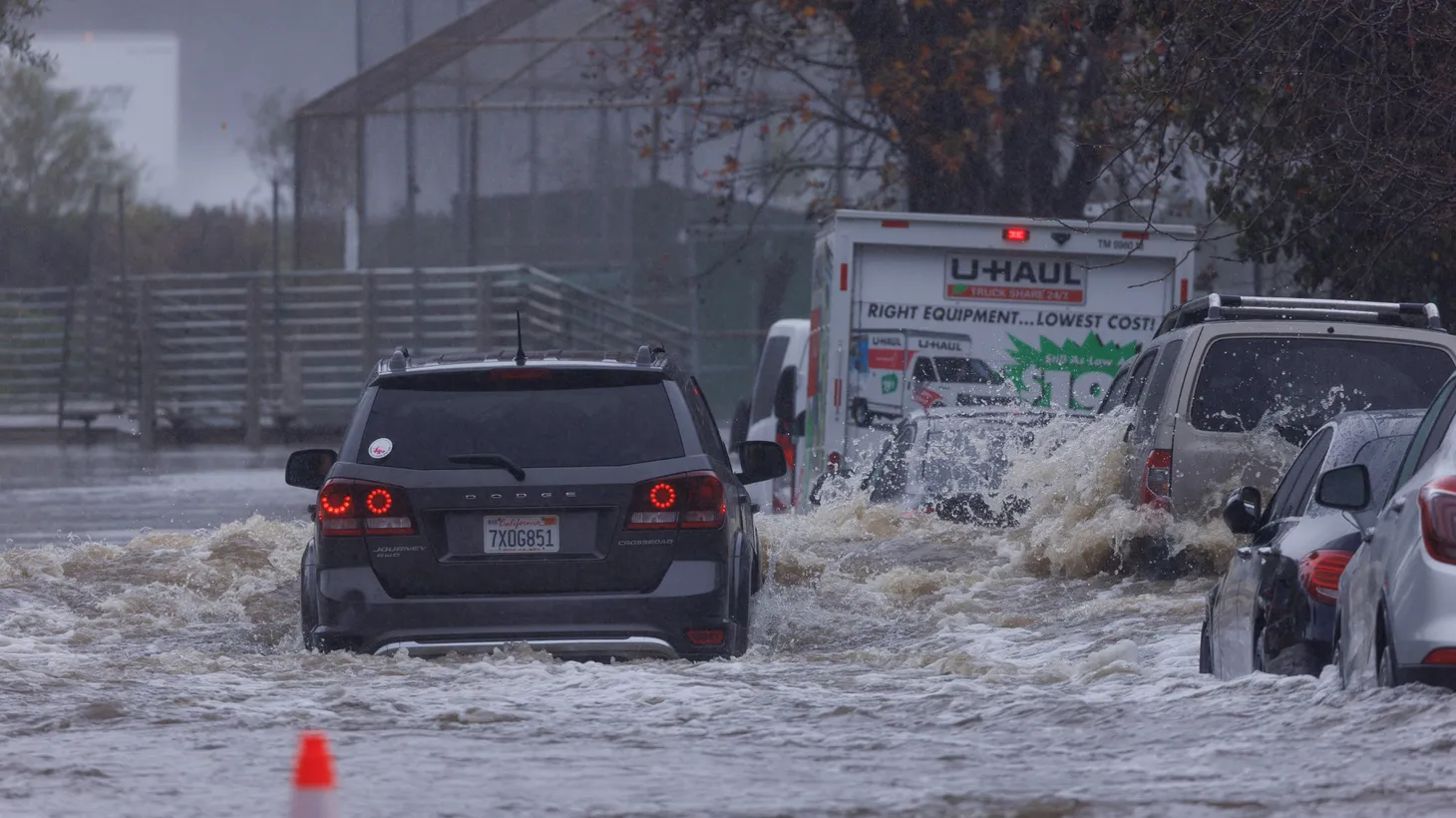 Drivers motor through a flooded street in San Diego, California, U.S., January 16, 2023.