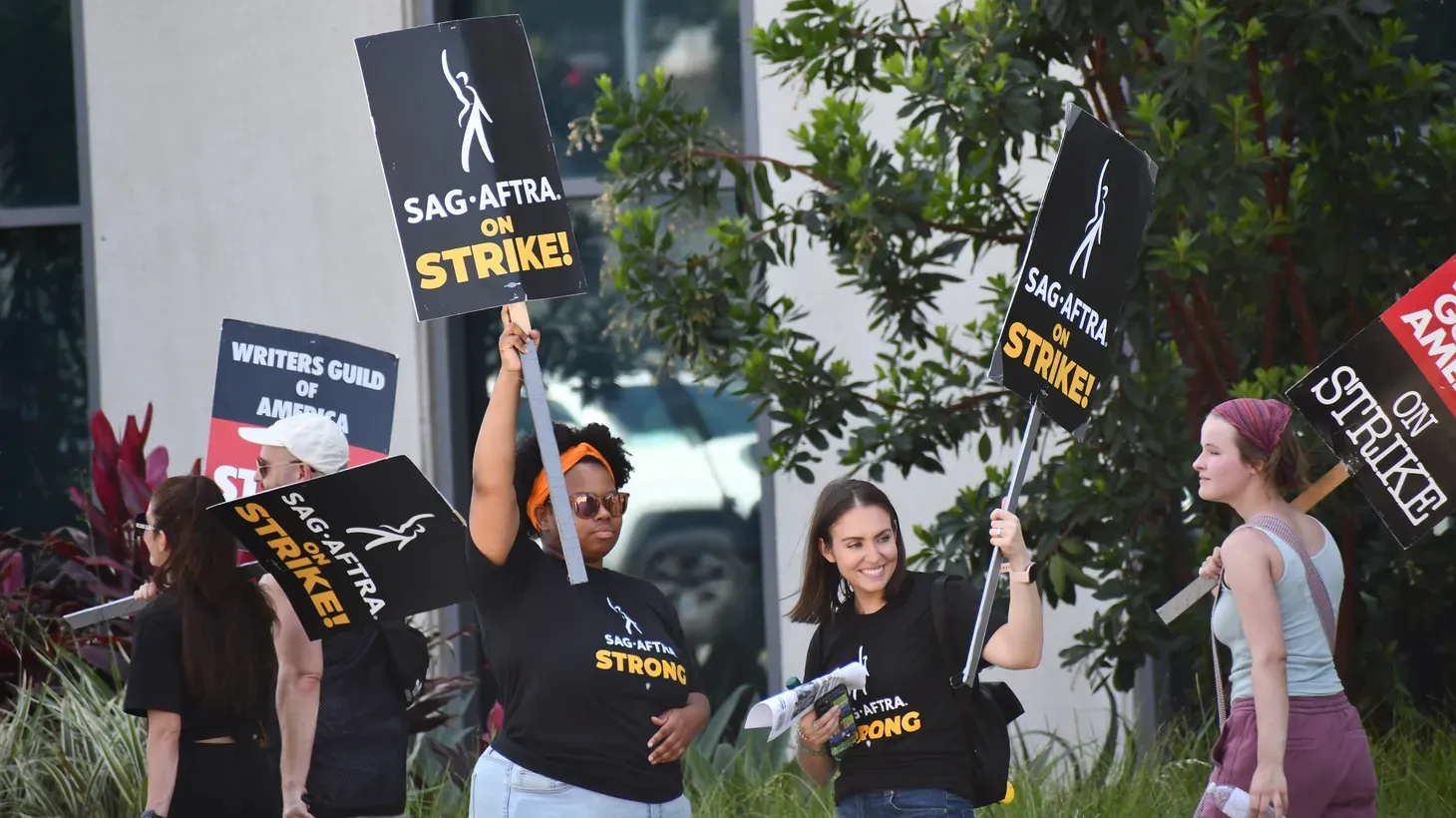 SAG-AFTRA members strike outside Netflix studios, July 27, 2023. 
As writers and actors fight for AI protections, studios are advertising AI jobs.