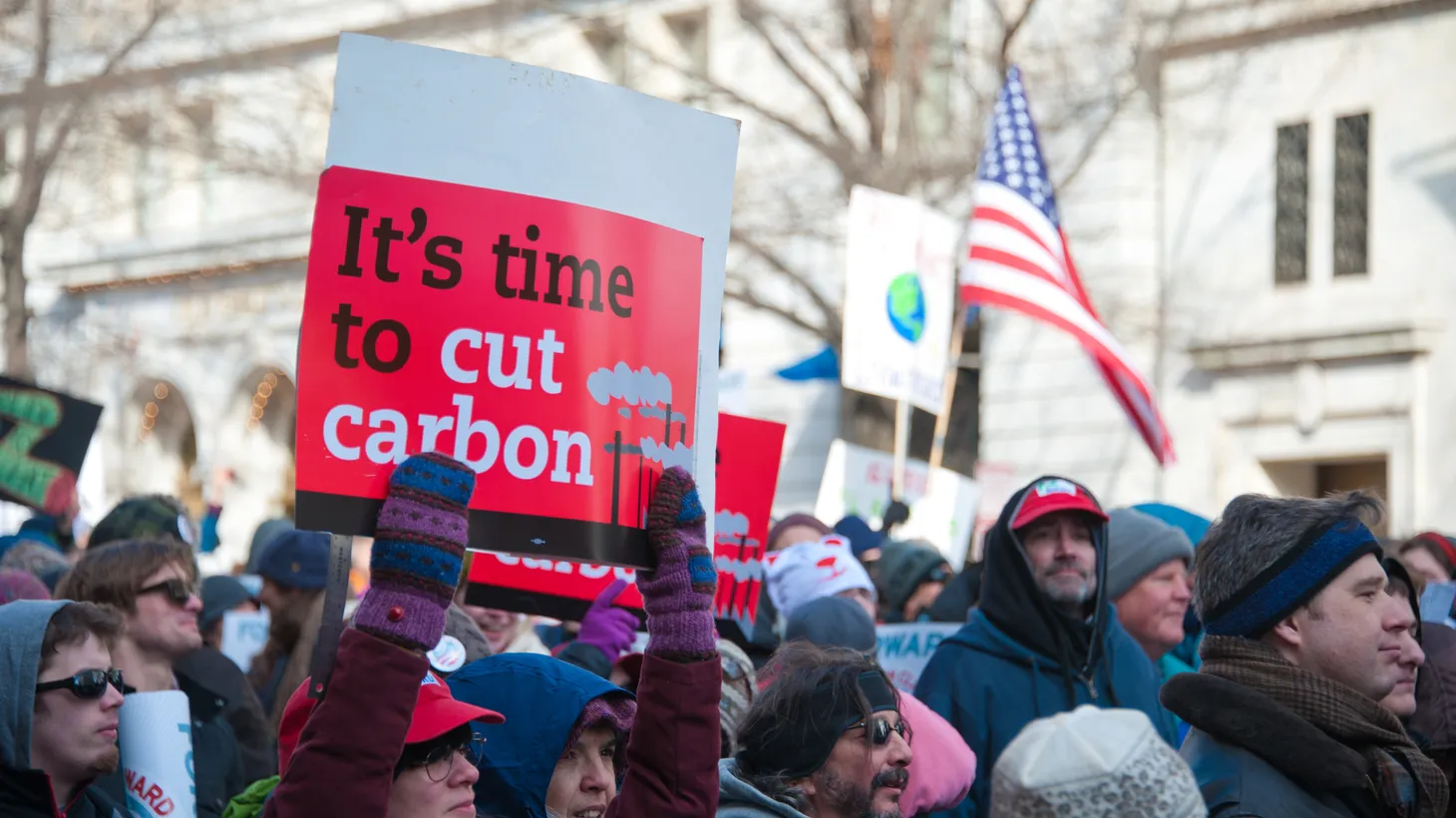 An activist holds a sign that says, “It’s time to cut carbon,” at a rally in Washington D.C.