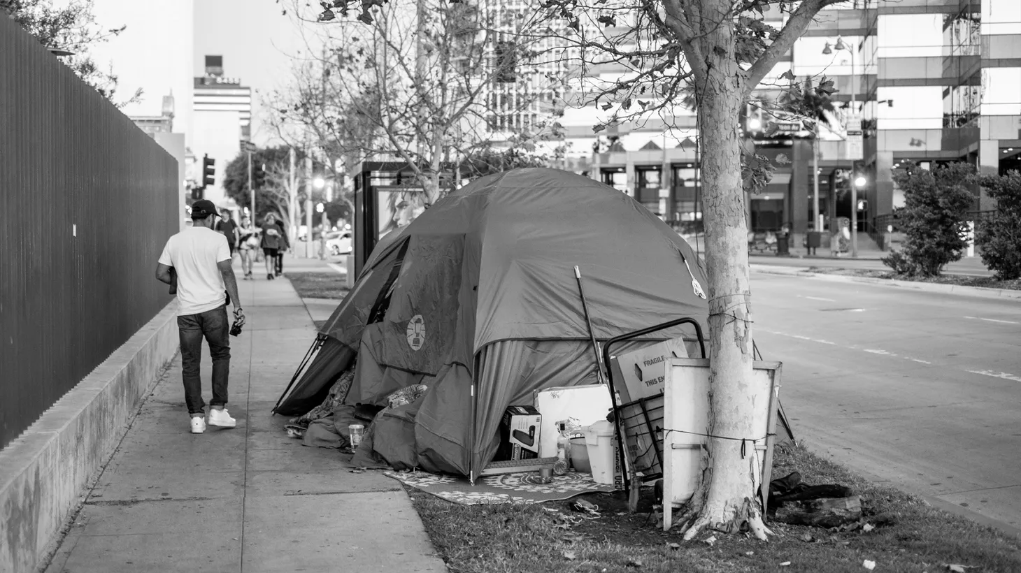 A homeless encampment sits on a sidewalk in Mid City, California.