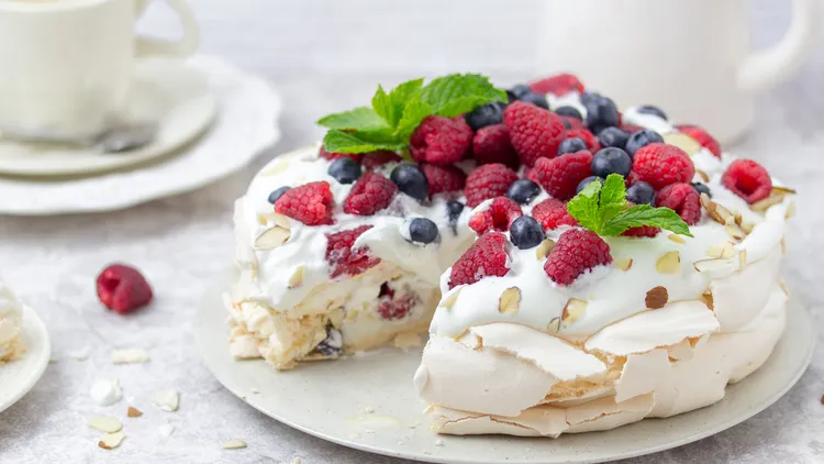 Pavlova features a soft-centered crunchy meringue that plays with whipped cream and fresh fruit. This time of year, berries are the star.