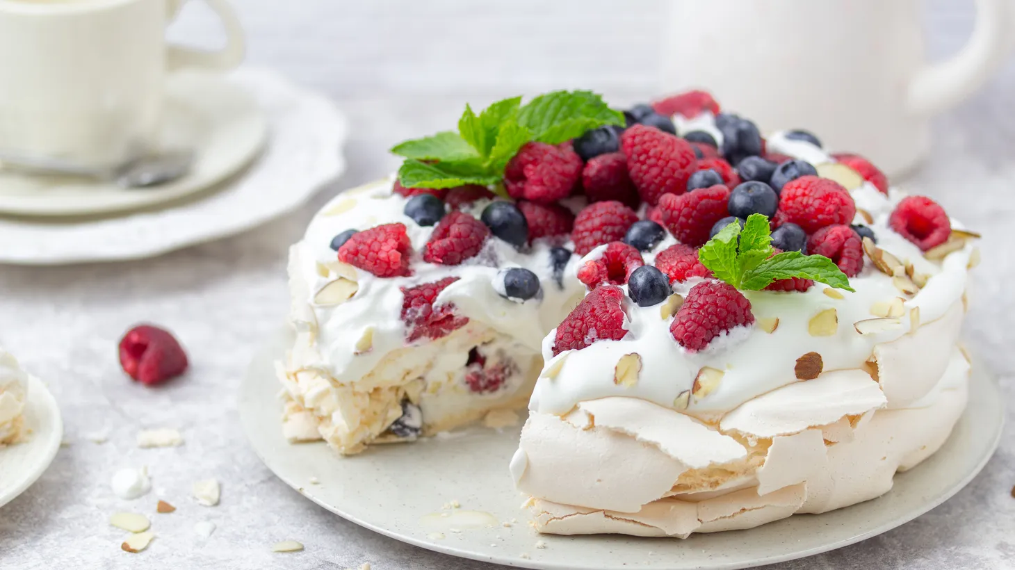 A classic pavlova is made in cake form, filled with berries and cream.