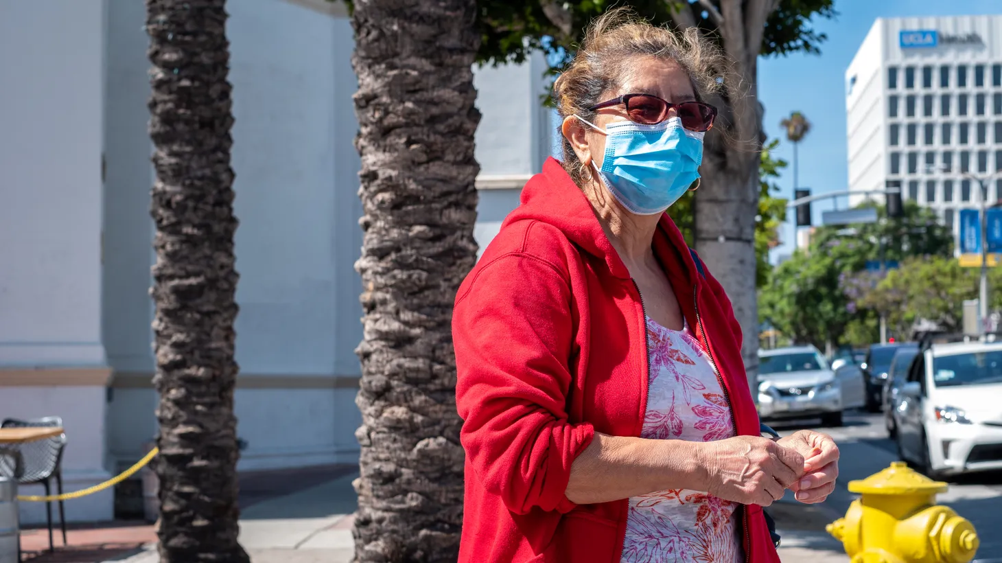 A woman wears a medical face mask in Westwood, California, July 22, 2022. “It's hard to keep our heads together when the risk of [COVID] cases is high, the risk of a really bad outcome is relatively low,” says UCSF’s Dr. Robert Wachter.
