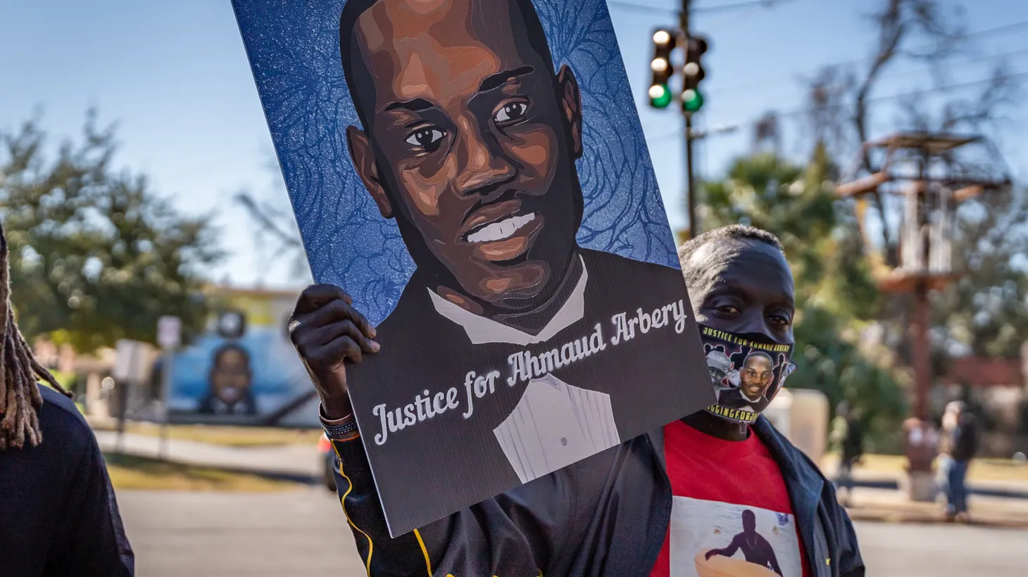 Marcus Arbery, Sr., father of Ahmaud Arbery, carries a portrait of his son in the Rev. Martin Luther King, Jr. Day Parade in Brunswick, Georgia, January 18, 2021.