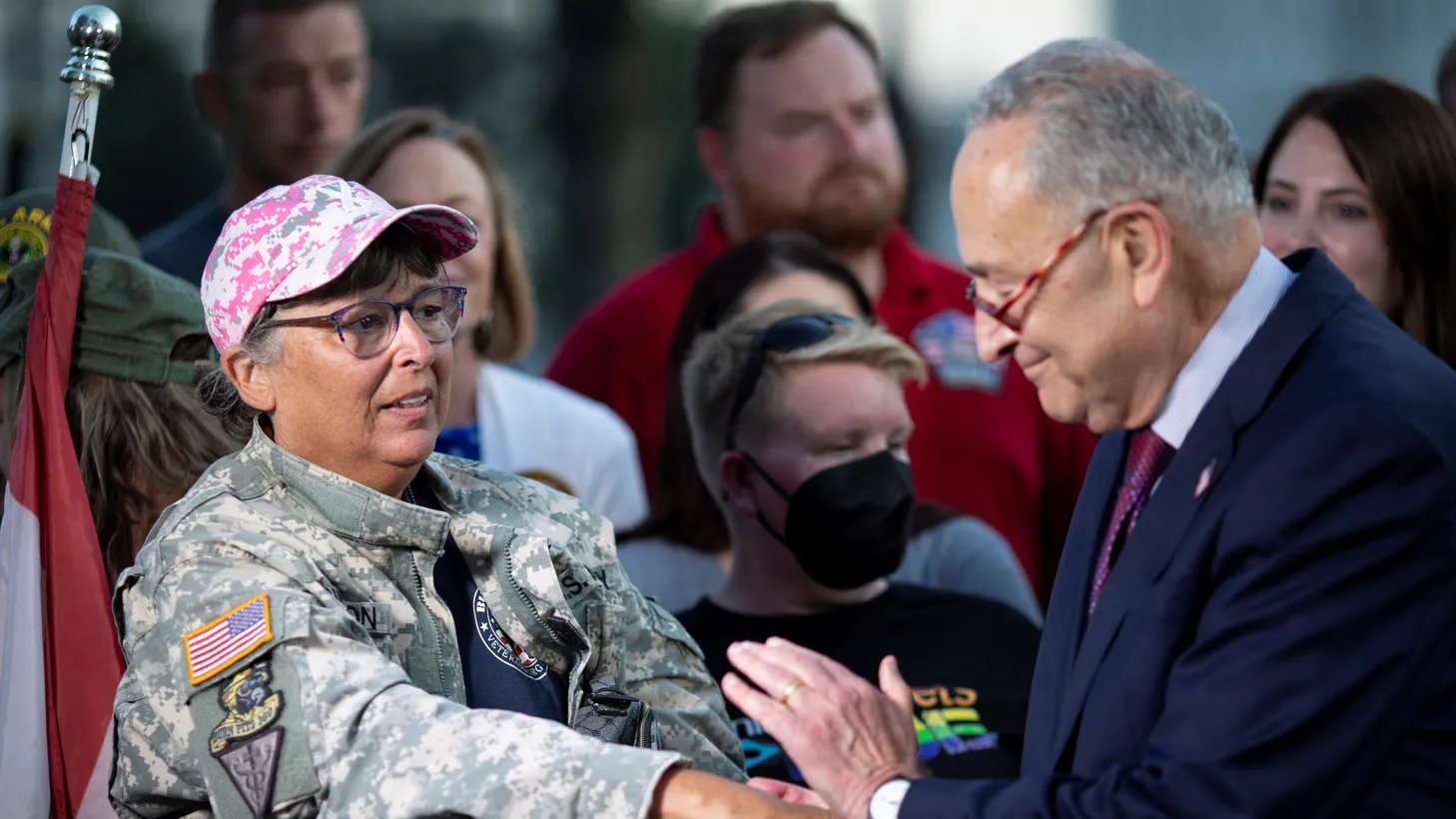 Senate Majority Leader Chuck Schumer (D-NY) embraces a veteran during a news conference, following the completion of a vote on the Promise to Address Comprehensive Toxics (PACT) Act on Capitol Hill in Washington, U.S., August 2, 2022.