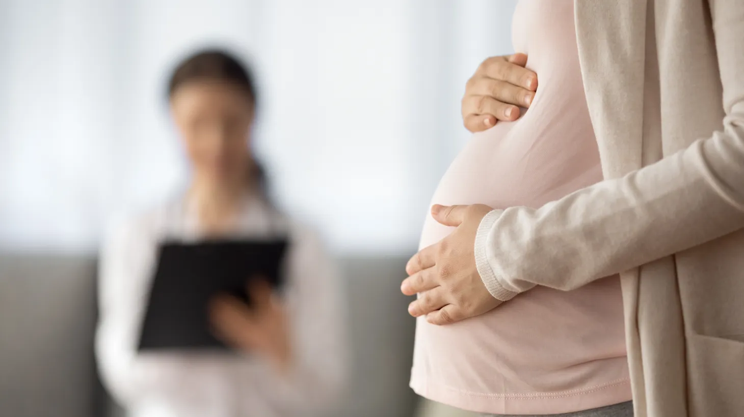 A pregnant person has a check-up with a physician at a health clinic.