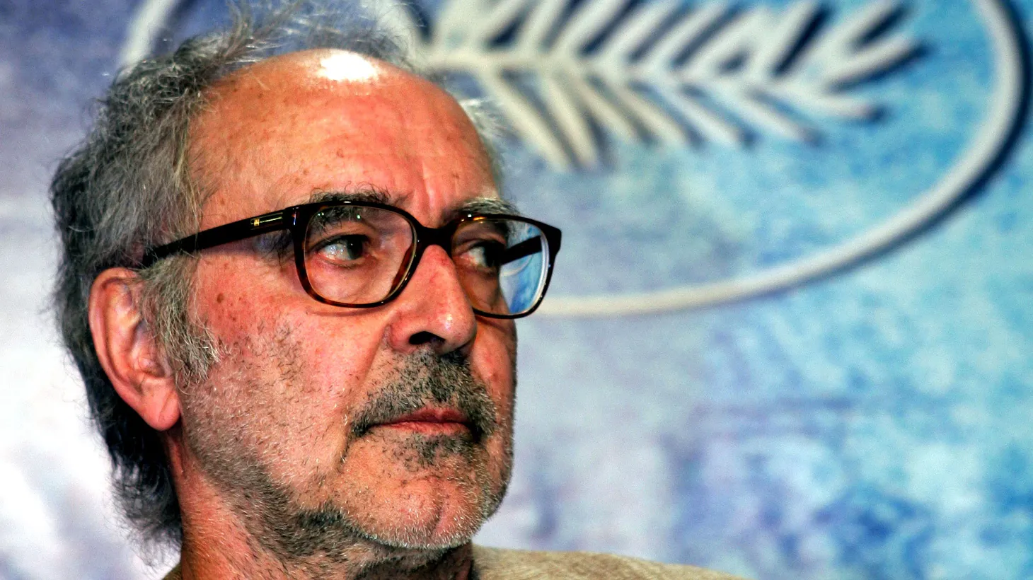 Swiss director Jean-Luc Godard listens to questions during a press conference for his film entry “Notre musique” at the 57th Cannes Film Festival, May 18, 2004.