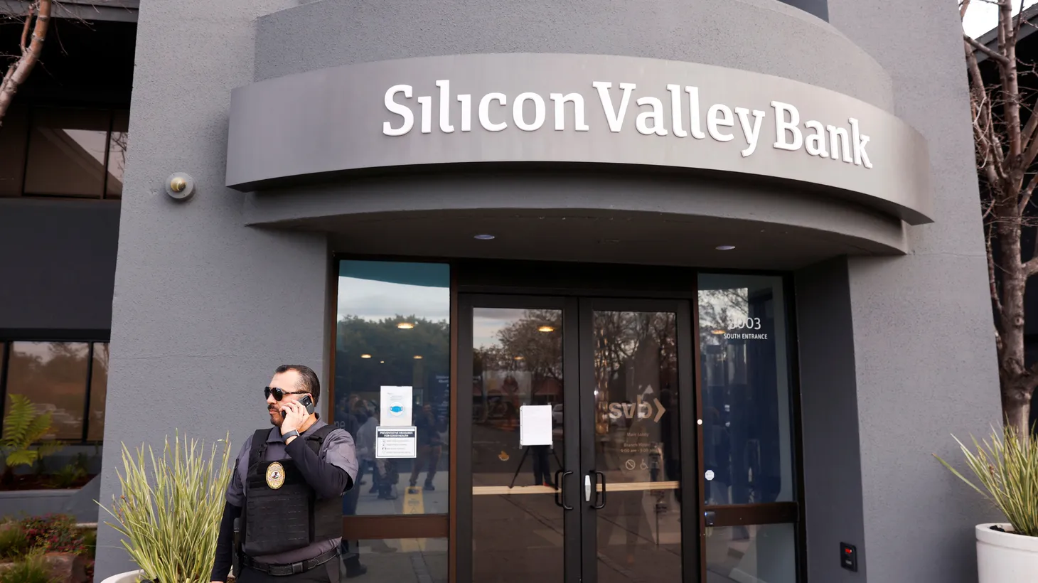 A security guard stands outside of the entrance of the Silicon Valley Bank headquarters in Santa Clara, California, U.S., March 13, 2023.