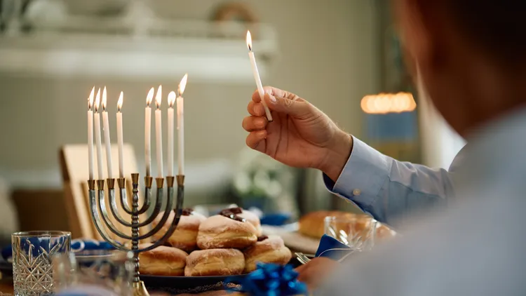 Hanukkah begins tonight, as the Israel-Hamas war continues. Some LA Jews are afraid to put up decorations, but one rabbi says it’s key to celebrate their identities.