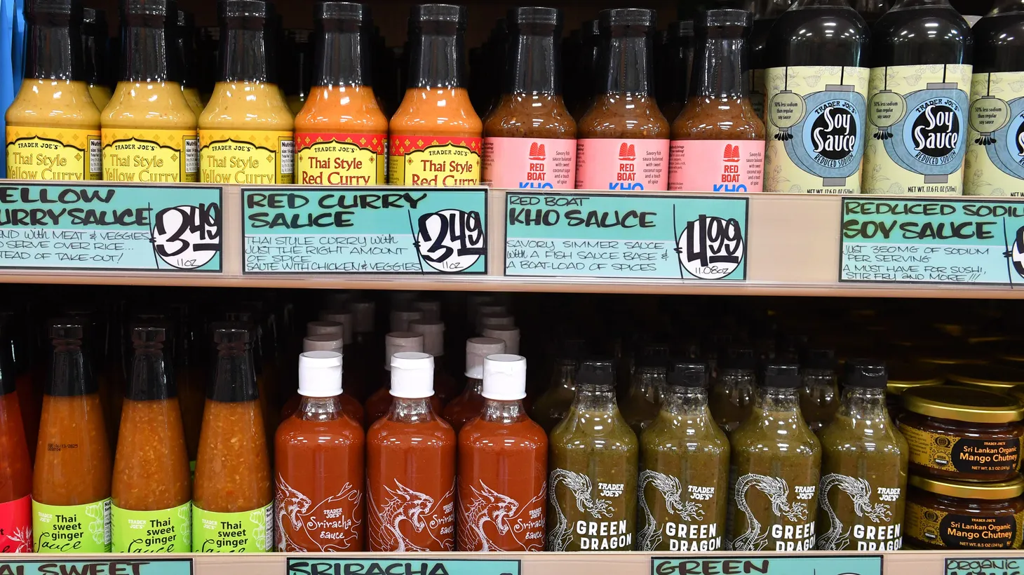 Asian sauces are displayed on a Trader Joe’s shelf.