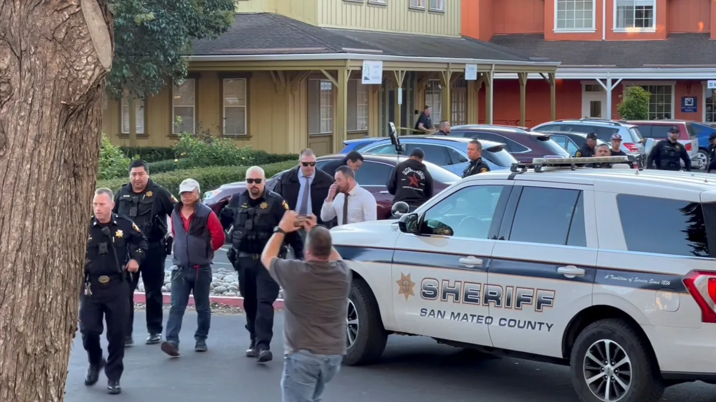 Police officers detain a man, believed to be the Half Moon Bay mass shooting suspect, in Half Moon Bay, California, U.S., January 23, 2023, in this screengrab taken from a social media video.