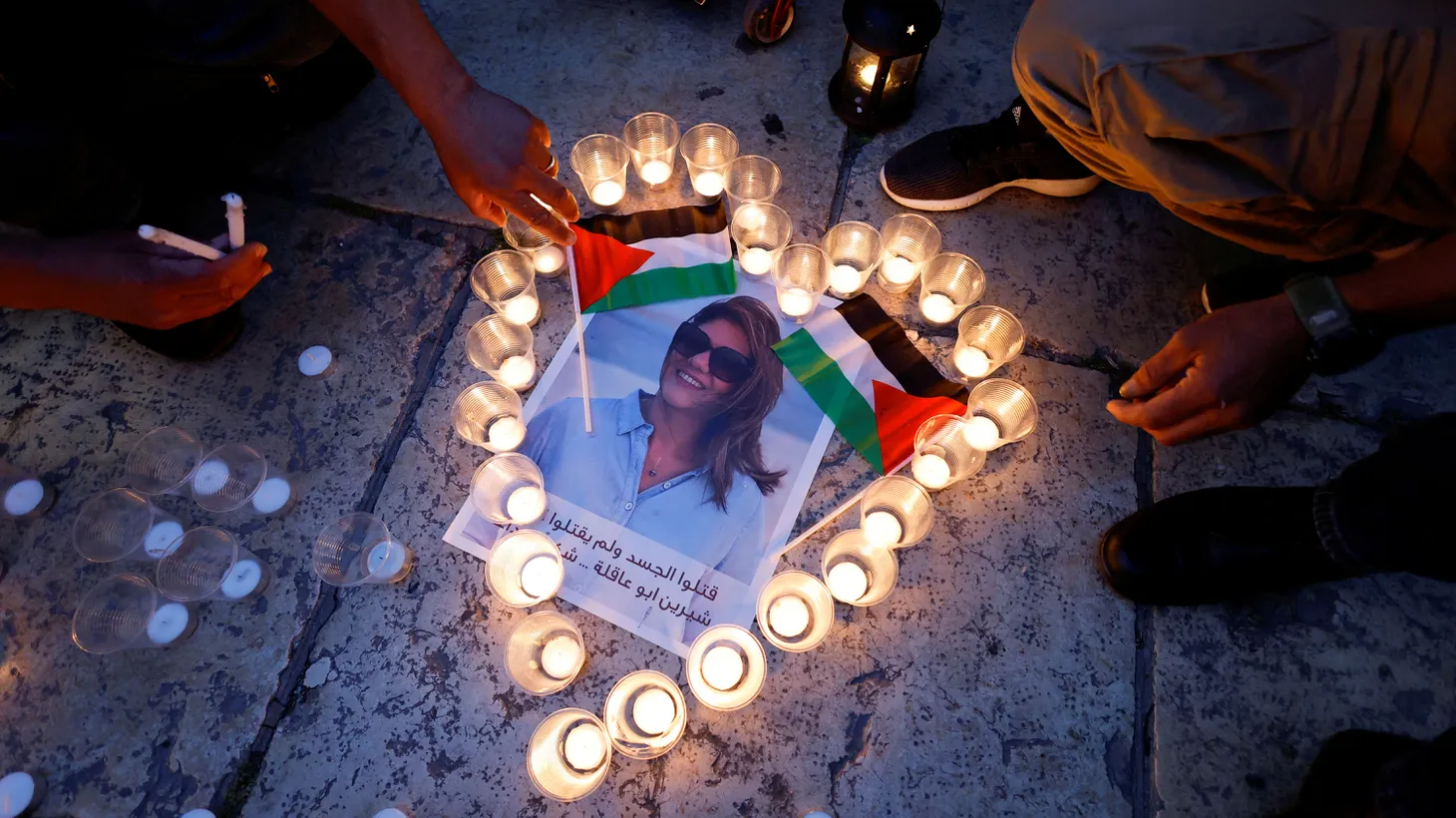 People light candles during a vigil in memory of Al Jazeera journalist Shireen Abu Akleh, who was killed during an Israeli raid, outside the Church of the Nativity in Bethlehem, in the Israeli-occupied West Bank, May 16, 2022.